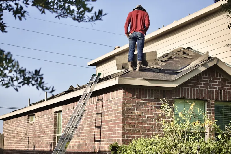 Professional roofer working on a residential roof in Bowman
